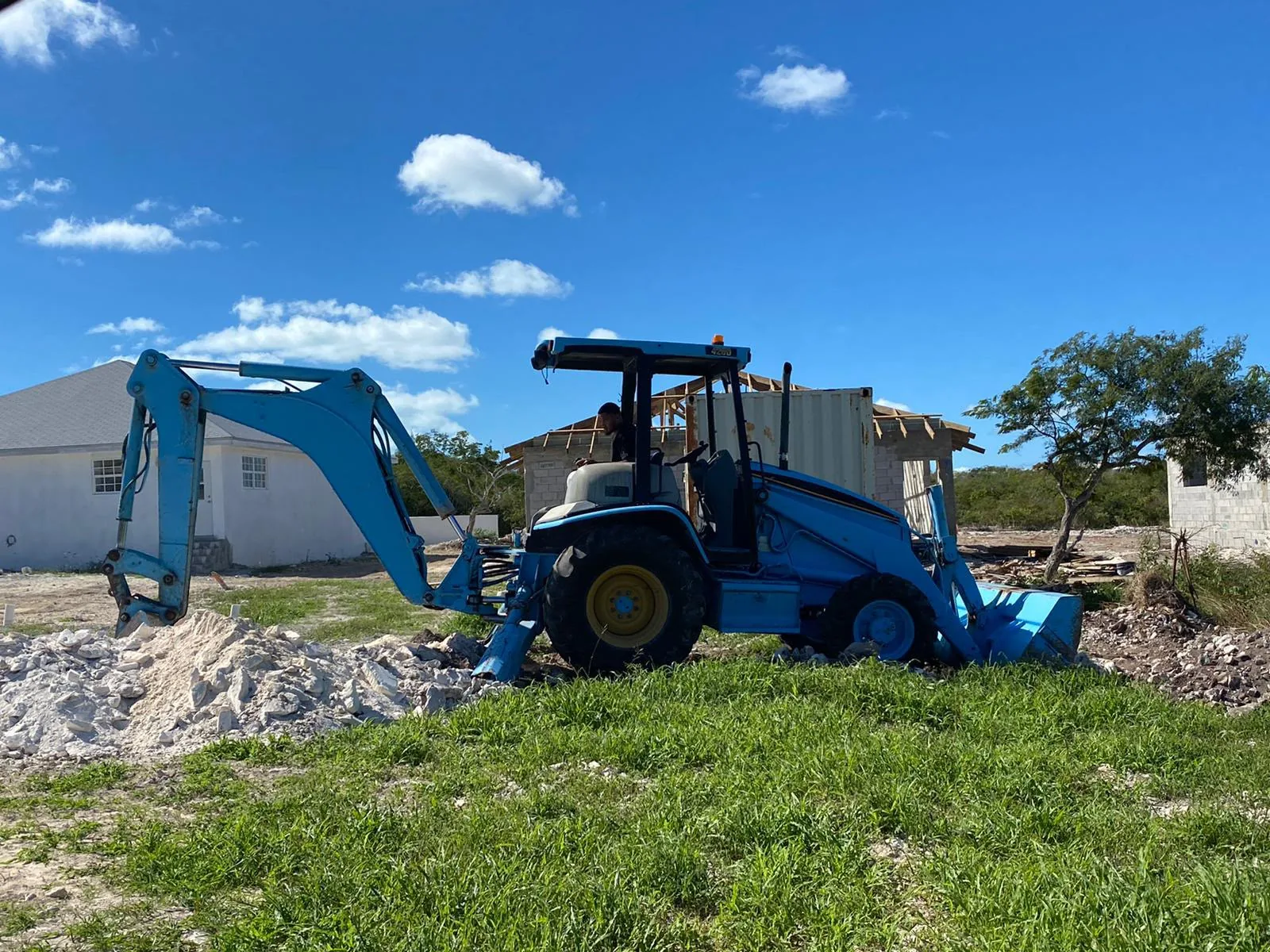 Backhoe loader preparing a project site