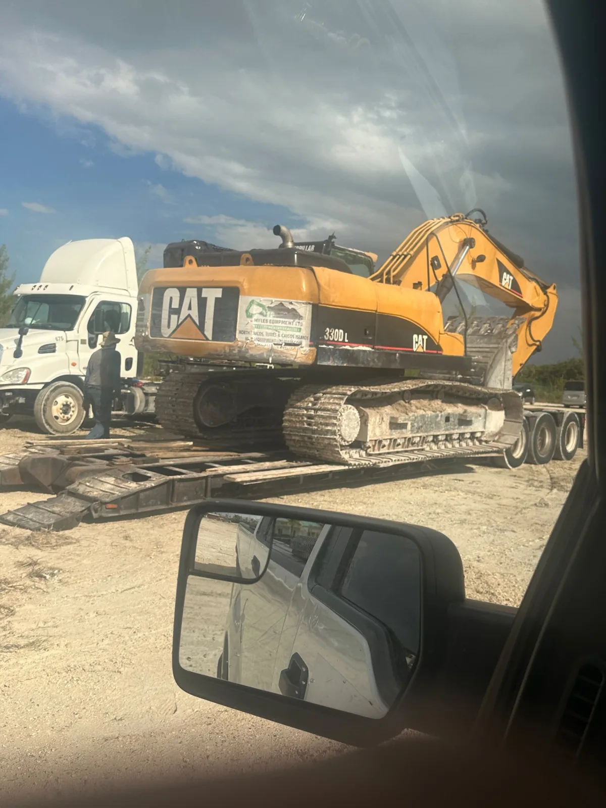 Caterpillar excavator transported on a lowboy trailer